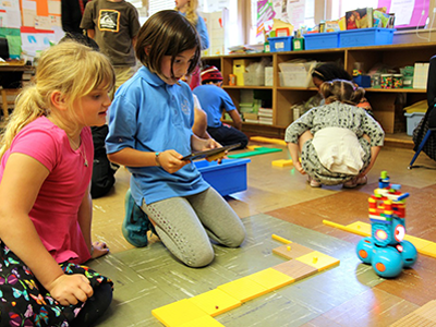 Girls programming a Dash robot